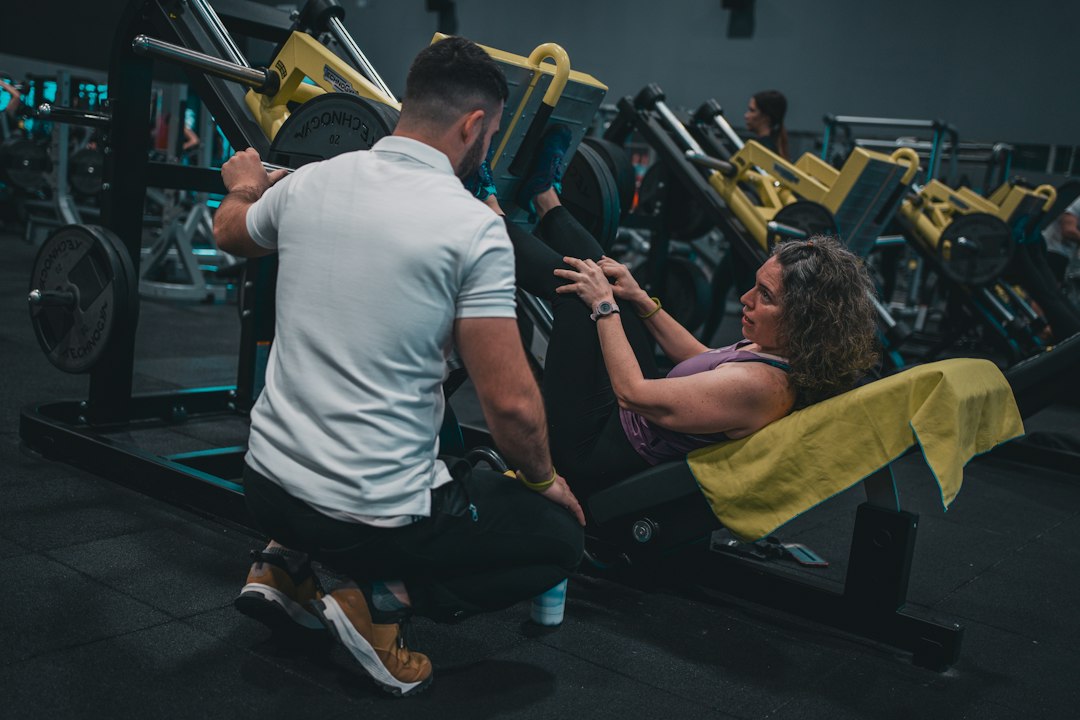Personal trainer coaching in gym