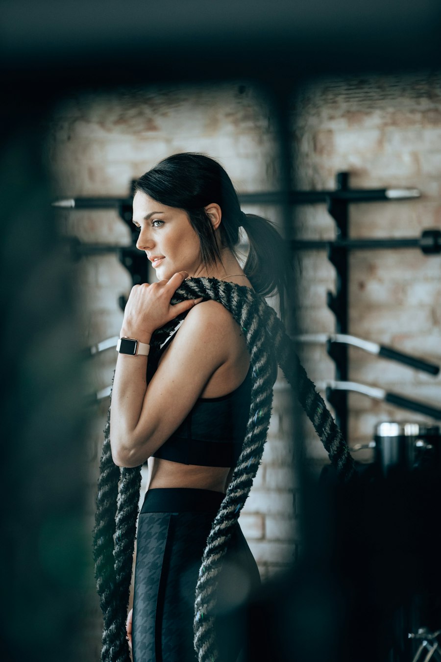 Illustrative photo of a woman training with battle ropes